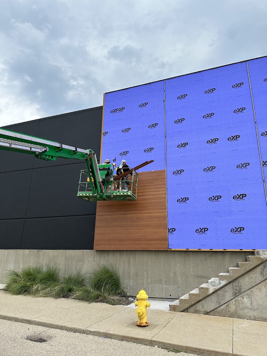 Commercial exterior siding installation on a boom lift