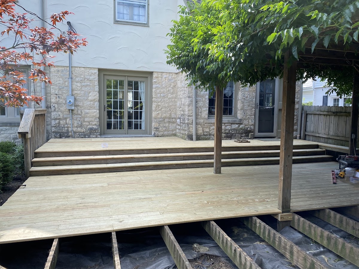 Large custom deck build against a stone home