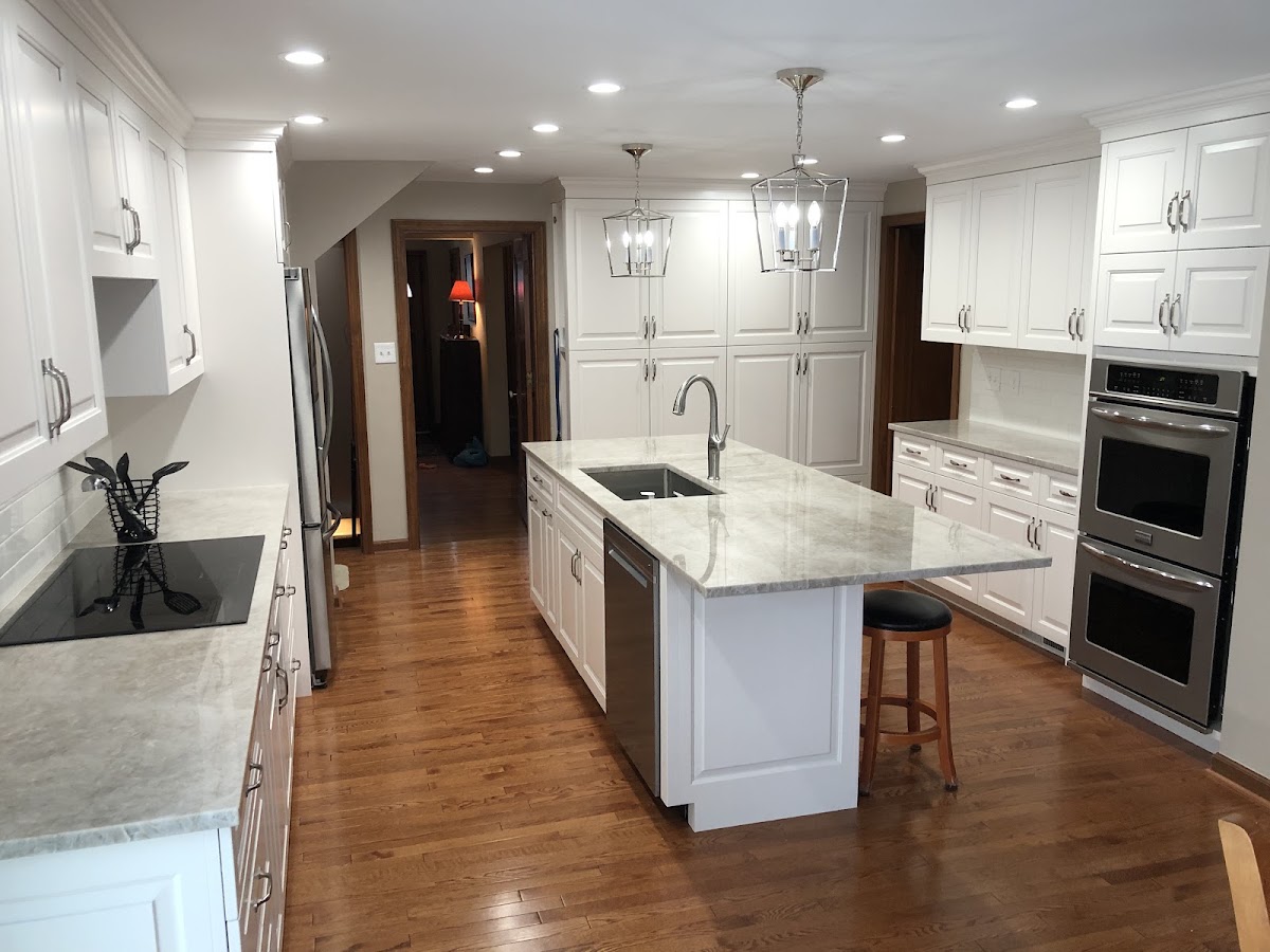 Finished kitchen remodel with white cabinets and quartz island