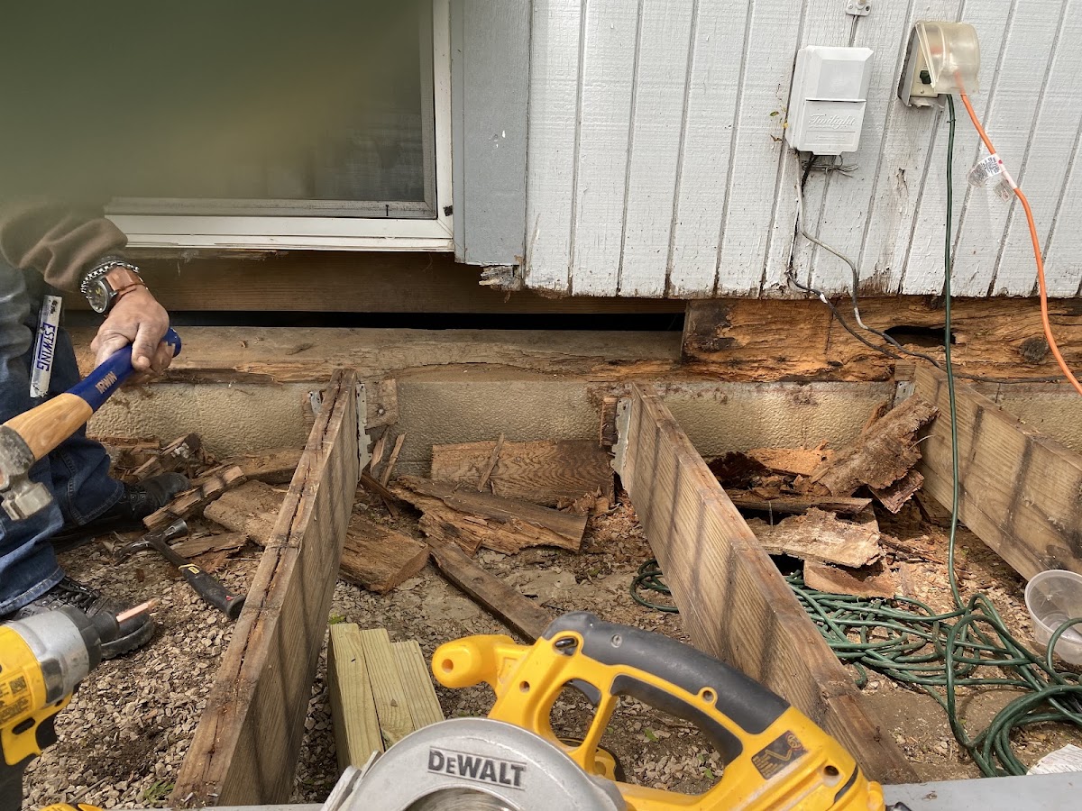 Structural repair work removing rotted wood siding and framing